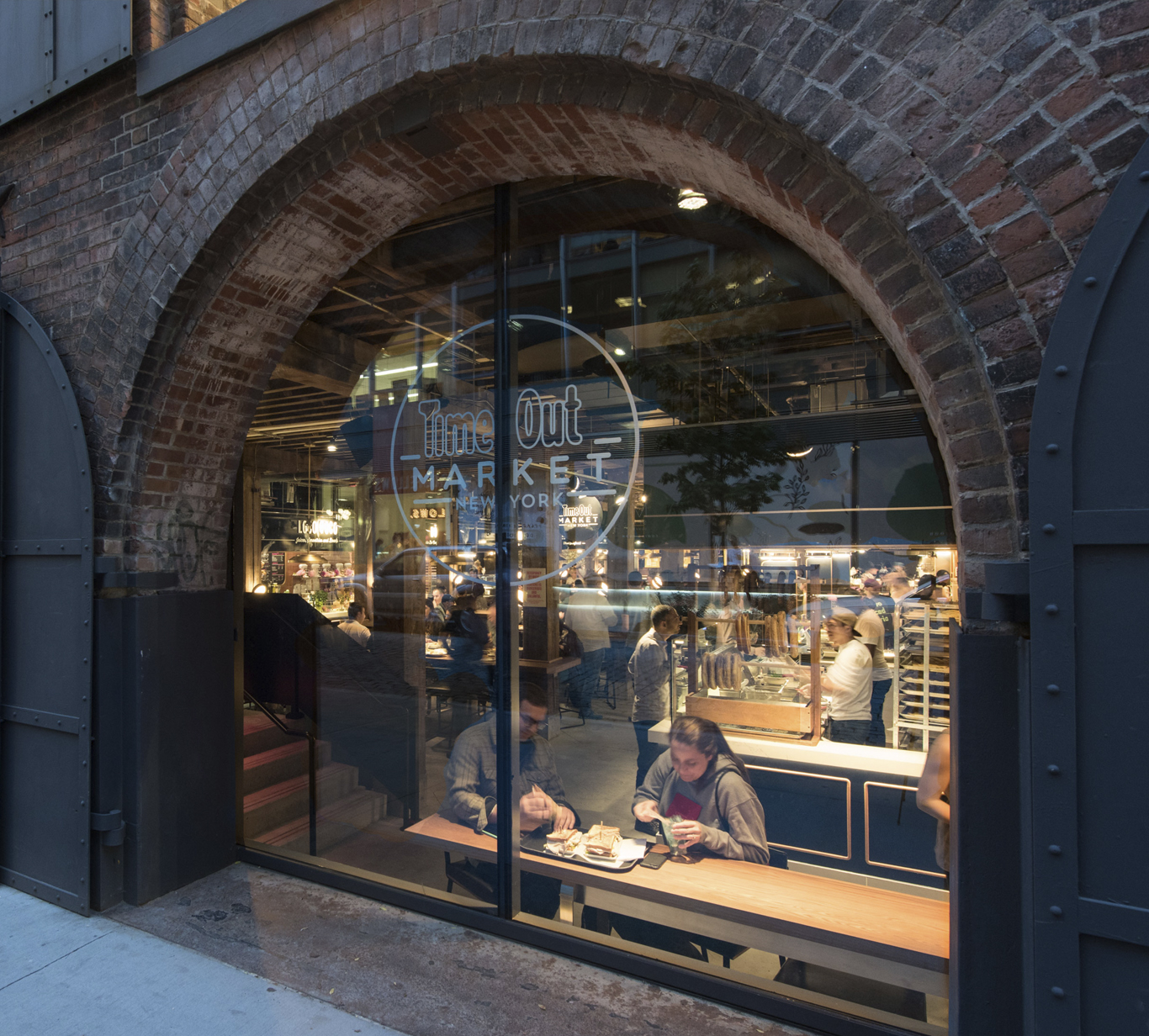Window of Time Out Market New York framed by exterior brick
